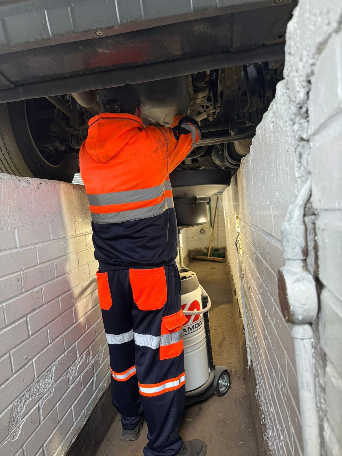 Tehnician LGTS la inspecție sub camion